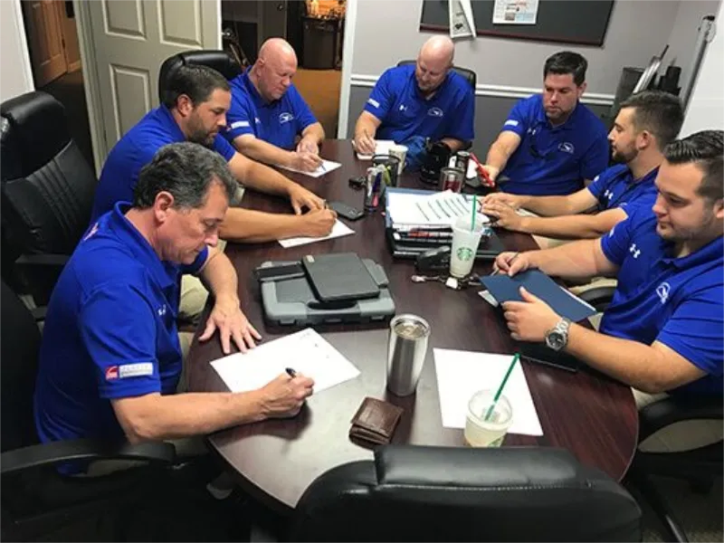 Staff at Masters Roofing meeting to discuss projects.