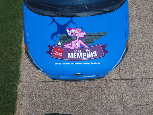 Roofing service car showing Owens Corning logo.